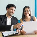 positive business executives laughing while reading contract 1262 18019 (1)